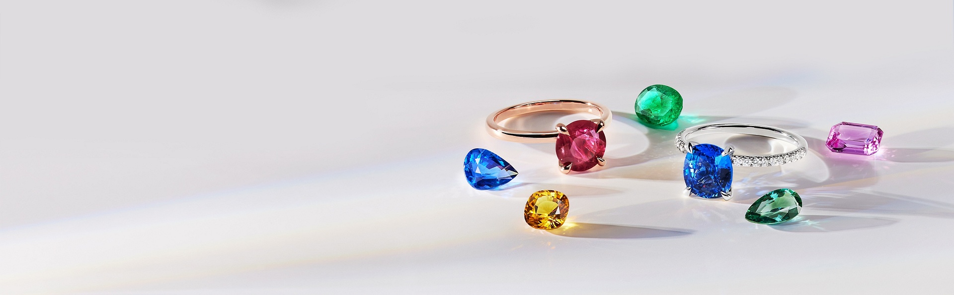 An assortment of popular loose gemstones lined up in various shapes